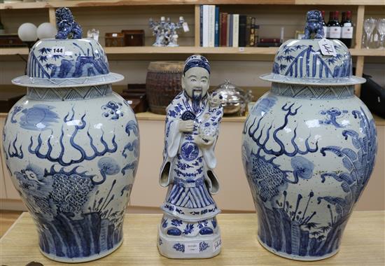 A pair of modern Chinese blue and white baluster vases and a blue and white figure of a sage holding a child tallest 65cm